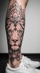 Realistic black and grey lion calf tattoo with geometric honeycomb, mandala pattern, and dotwork shading