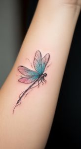 Delicate watercolor dragonfly tattoo with soft gradient colors on fair inner forearm, fine linework detail