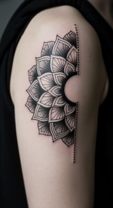 Detailed black ink mandala tattoo on upper arm with dotwork shading, soft light, smooth skin.