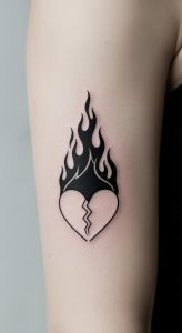 Minimal black broken heart and flame tattoo on upper inner arm, crisp linework, soft lighting