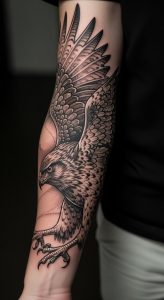 Close-up forearm with realistic black-and-gray hawk tattoo, fine line shading, dotwork, sharp focus