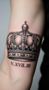 Close-up forearm tattoo with black and gray realistic crown, fine linework, Roman numerals, soft lighting.